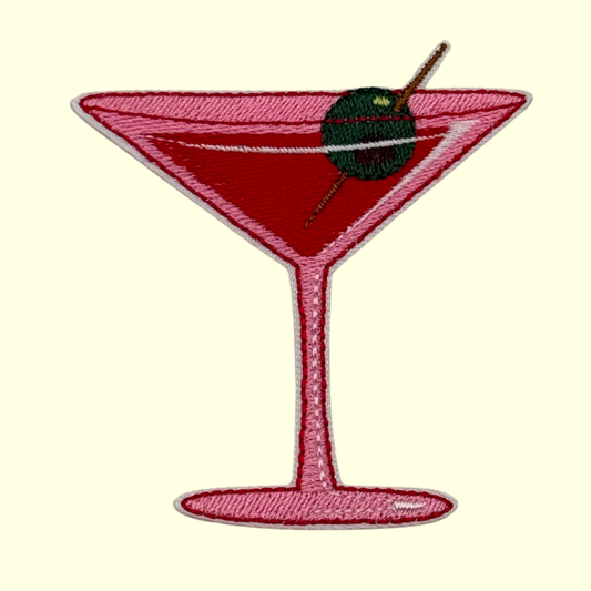 Pink Martini Glass with an Olive